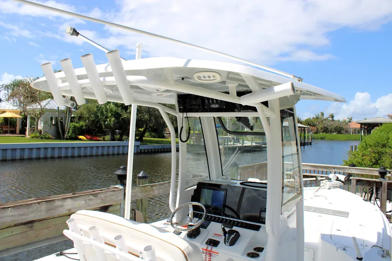 Slide: The Image of 2022 Sea Hunt BX25FS boat with advanced navigation system docked by a scenic canal. - 22