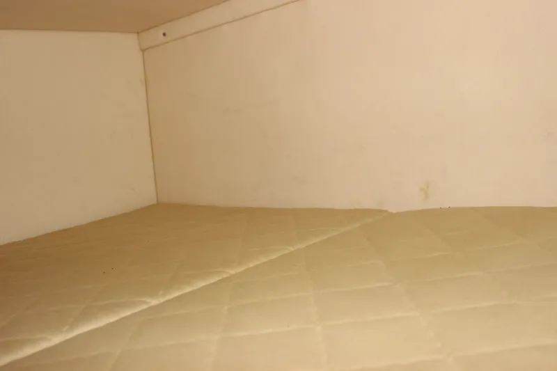 Slide: The Image of Interior cabin of 2007 Sea Ray 240 Sundancer with beige quilted upholstery. - 20