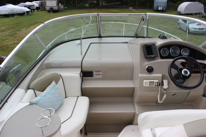 Slide: The Image of 2007 Sea Ray 240 Sundancer cockpit with steering wheel, gauges, and seating area. - 33