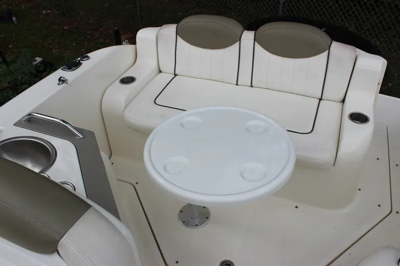 Slide: The Image of 2007 Sea Ray 240 Sundancer boat interior with seating and table. - 16