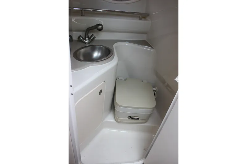 Slide: The Image of Compact bathroom in 2007 Sea Ray 240 Sundancer boat with sink and portable toilet. - 30