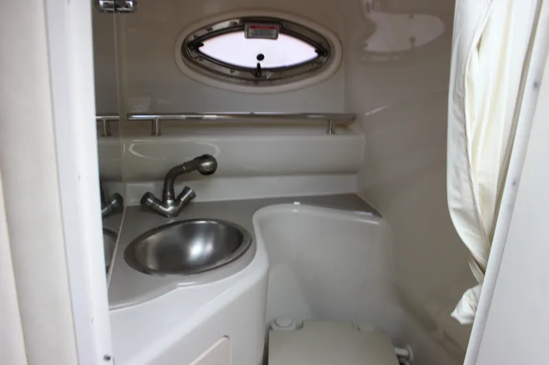 Slide: The Image of Compact bathroom in 2007 Sea Ray 240 Sundancer boat with sink and porthole window. - 32