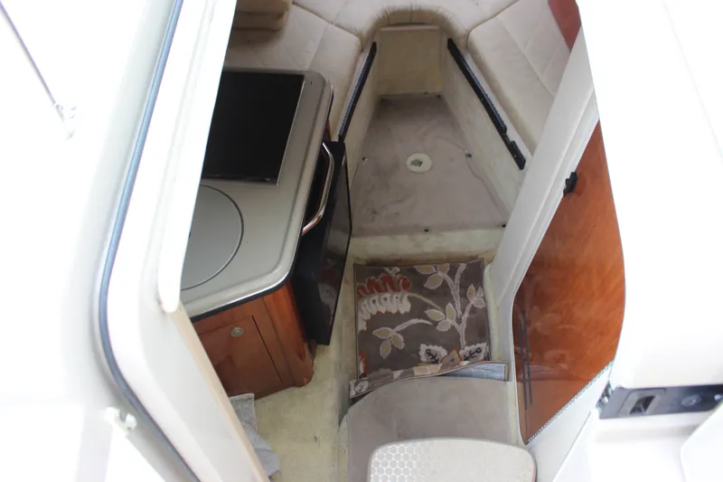 Slide: The Image of 2007 Sea Ray 240 Sundancer cabin interior with seating, table, and floral cushion. - 27