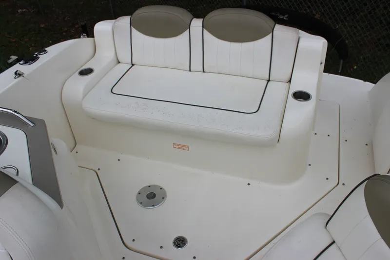 Slide: The Image of 2007 Sea Ray 240 Sundancer boat interior with white seating and cup holders. - 13