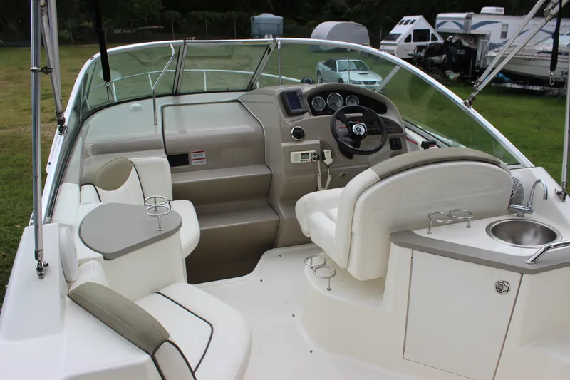 Slide: The Image of 2007 Sea Ray 240 Sundancer boat interior with helm, seating, and sink. - 15