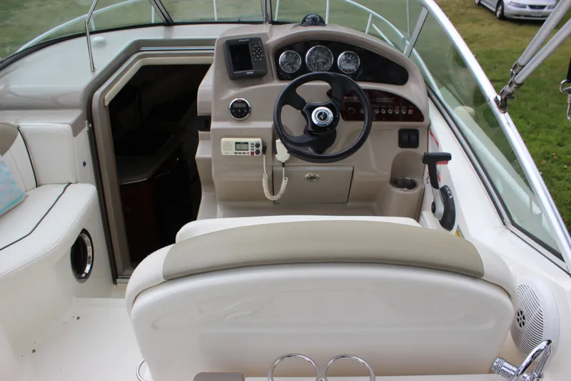 Slide: The Image of 2007 Sea Ray 240 Sundancer boat cockpit with steering wheel and control panel. - 24