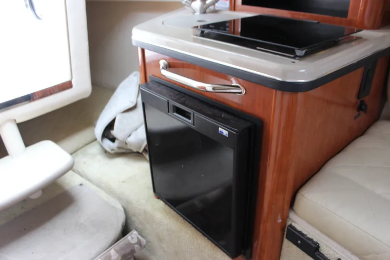 Slide: The Image of 2007 Sea Ray 240 Sundancer cabin interior with compact fridge and countertop. - 29