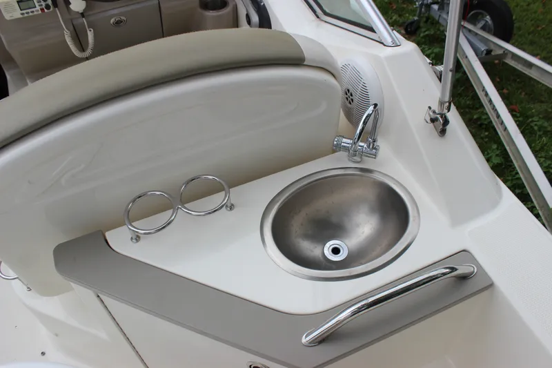 Slide: The Image of 2007 Sea Ray 240 Sundancer boat interior with sink and cup holders. - 25