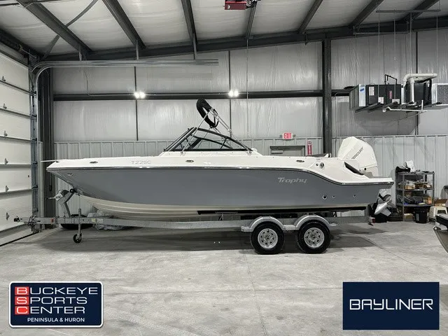 The Image of A 2025 Trophy T22SC boat on a trailer inside a warehouse. - 1