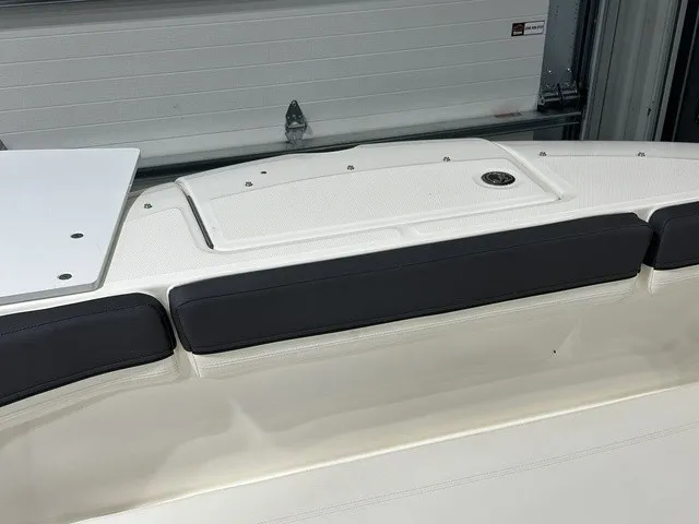 Slide: The Image of The image shows the deck of a 2025 Trophy T22SC boat with cushioned seating areas. - 32