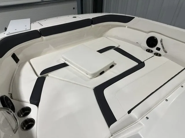 Slide: The Image of The image shows the cockpit of a 2025 Trophy T22SC boat with white upholstery. - 29