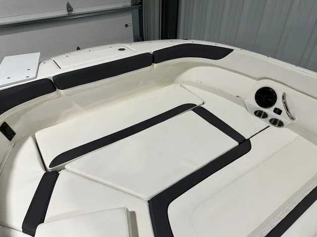 Slide: The Image of The image shows the cockpit of a 2025 Trophy T22SC boat with white and black upholstery. - 30