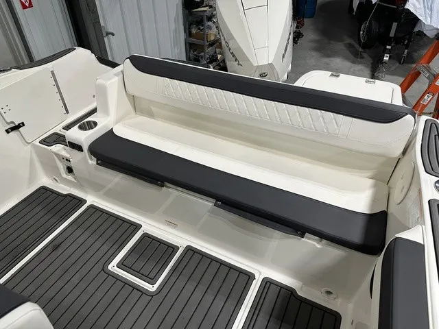 Slide: The Image of The rear seating of a 2025 Trophy T22SC with black and white upholstery and gray flooring. - 36