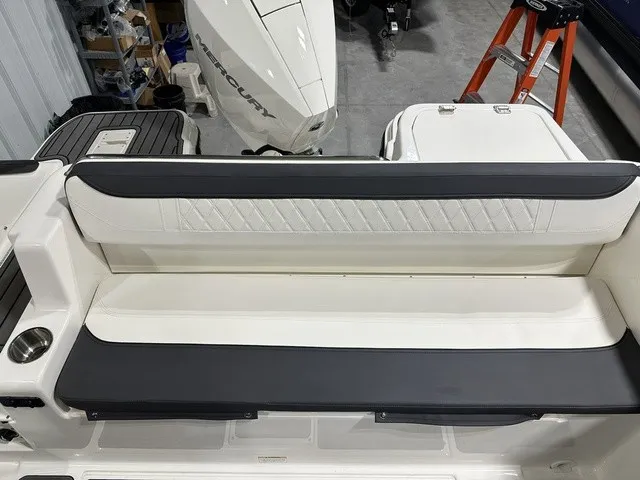 Slide: The Image of The rear bench seat of a Trophy T22SC boat with white and black upholstery. - 9