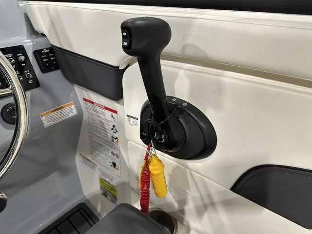 Slide: The Image of Close-up of a boat throttle lever with safety lanyard and labels. - 23