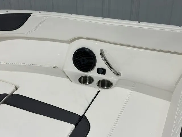 Slide: The Image of The image shows a boat interior with white upholstery, a speaker, and cup holders. - 31
