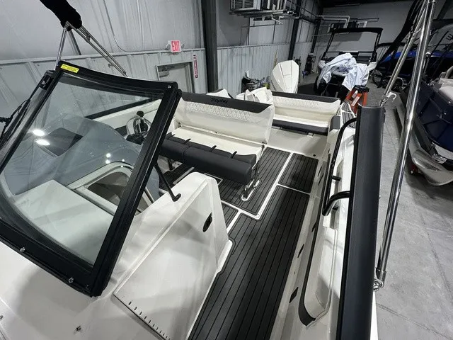 Slide: The Image of The image shows the interior of a 2025 Trophy T22SC boat with modern seating and controls. - 34