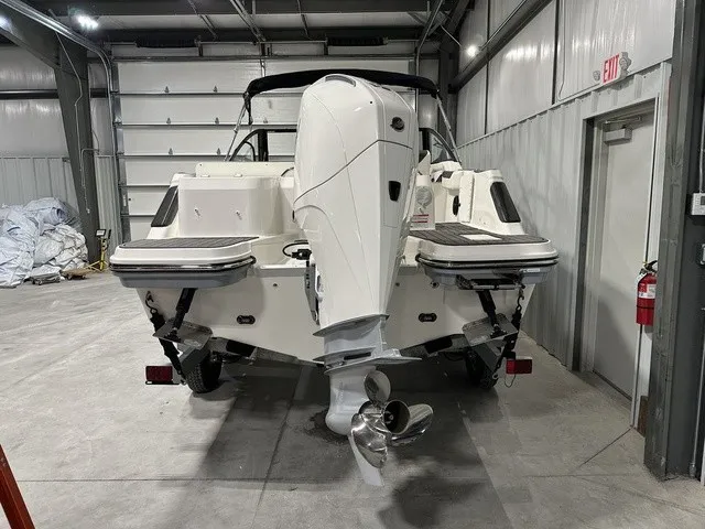 Slide: The Image of The image shows the rear of a white boat with an outboard motor in a storage facility. - 4