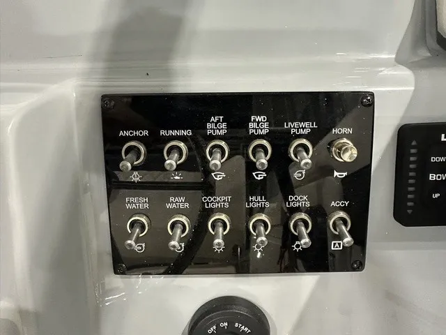 Slide: The Image of Control panel with various switches for anchor, bilge pumps, lights, and more on a Trophy T22SC boat. - 21