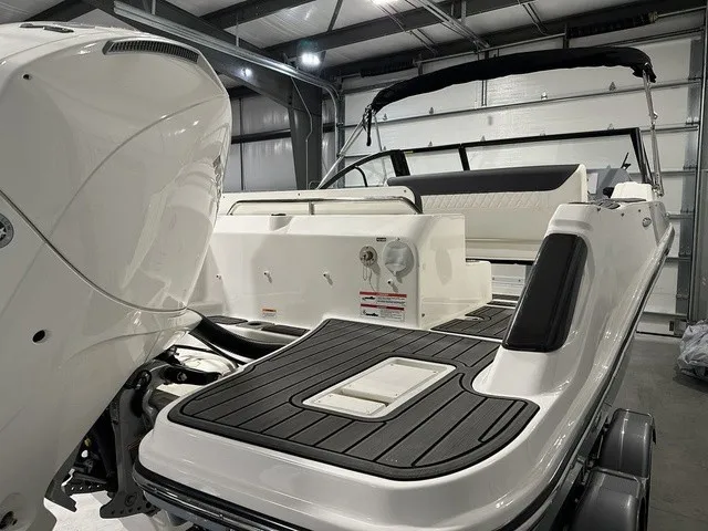 Slide: The Image of The image shows the stern of a 2025 Trophy T22SC boat in a storage facility. - 7