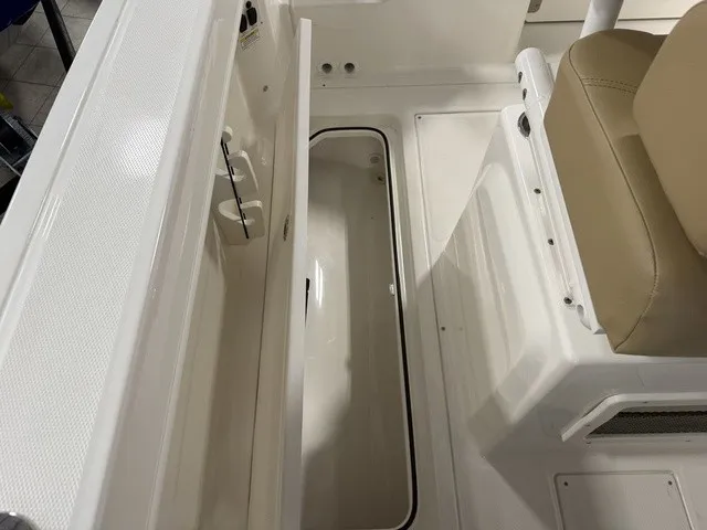 Slide: The Image of The image shows the interior of a 2025 Trophy T24CC boat with an open storage compartment. - 35