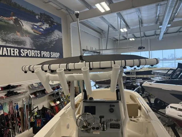 Slide: The Image of The image shows the cockpit of a Trophy T24CC boat in a showroom with water sports gear. - 37