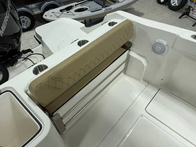 Slide: The Image of The 2025 Trophy T24CC features a beige fold-down seat and stainless steel cup holders. - 13