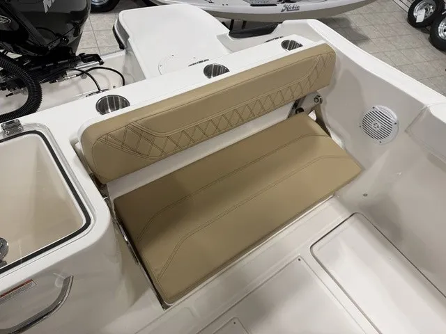 Slide: The Image of The 2025 Trophy T24CC features a beige bench seat with elegant stitching and cup holders. - 12