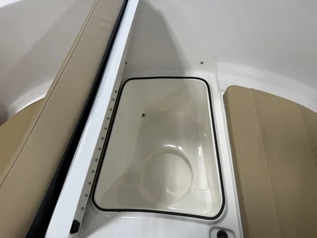 Slide: The Image of The image shows a white storage compartment on a boat with beige upholstery. - 29