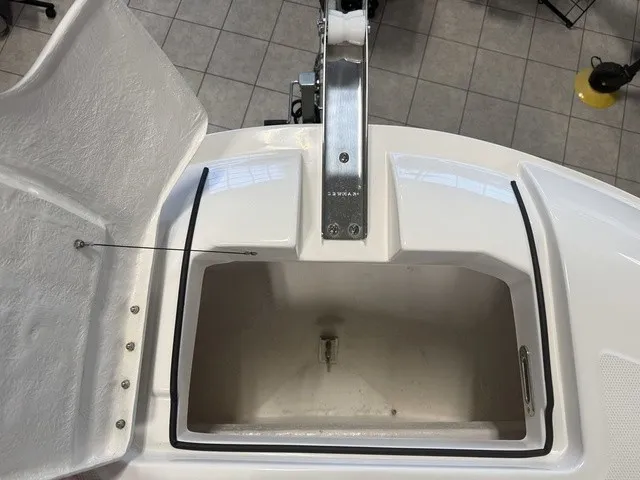 Slide: The Image of An open storage compartment on a boat with a white interior and metal fittings. - 31