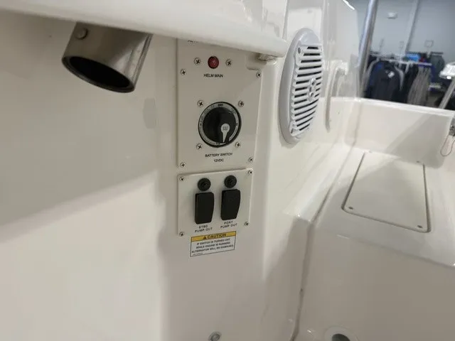 Slide: The Image of Close-up of a control panel on a 2025 Trophy T24CC boat with switches and speaker. - 36