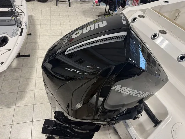 Slide: The Image of A Mercury outboard motor is mounted on a boat, which is on a tiled floor. - 7