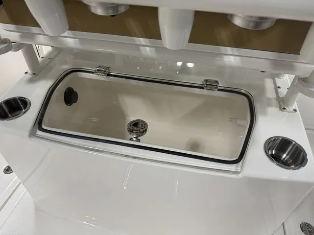 Slide: The Image of The image shows a white boat with a built-in storage compartment and cup holders. - 15
