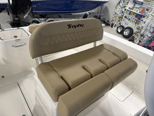 Slide: The Image of The image shows a beige cushioned bench seat on a 2025 Trophy T24CC boat. - 16
