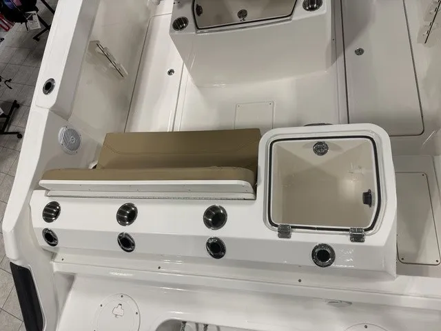 Slide: The Image of The image shows the cockpit of a 2025 Trophy T24CC boat with seating and storage. - 9