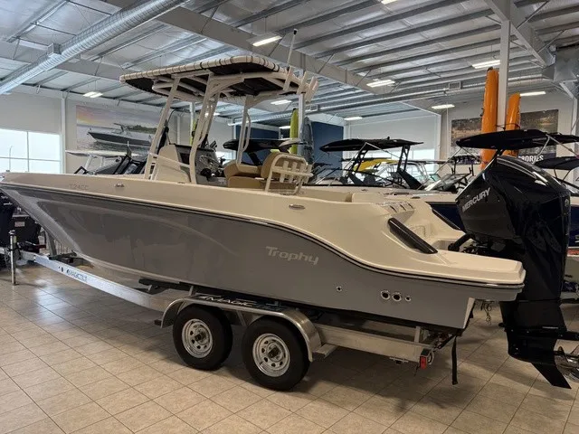Slide: The Image of A 2025 Trophy T24CC boat on a trailer in a showroom. - 5