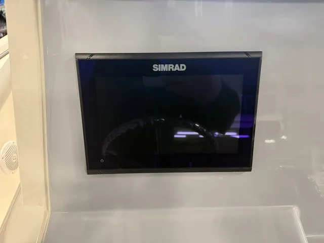 Slide: The Image of A Simrad screen is integrated into the dashboard of a boat. - 22