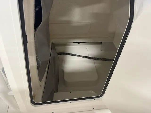 Slide: The Image of Interior view of a boat storage compartment with white walls and a gray curtain. - 33
