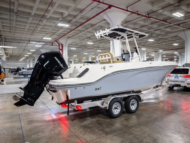 Slide: The Image of A 2025 Trophy T24CC boat on a trailer in a large warehouse. - 4