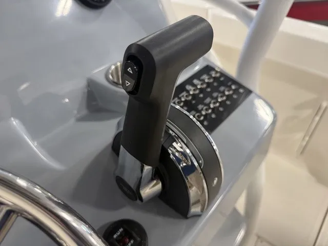 Slide: The Image of Close-up of a throttle lever on a boat, surrounded by controls and a steering wheel. - 20