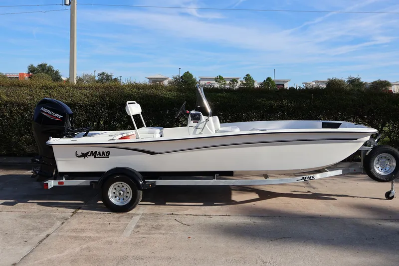 Slide: The Image of 2027 Mako Pro Skiff 17 CC boat on trailer, side view, outdoors. - 3