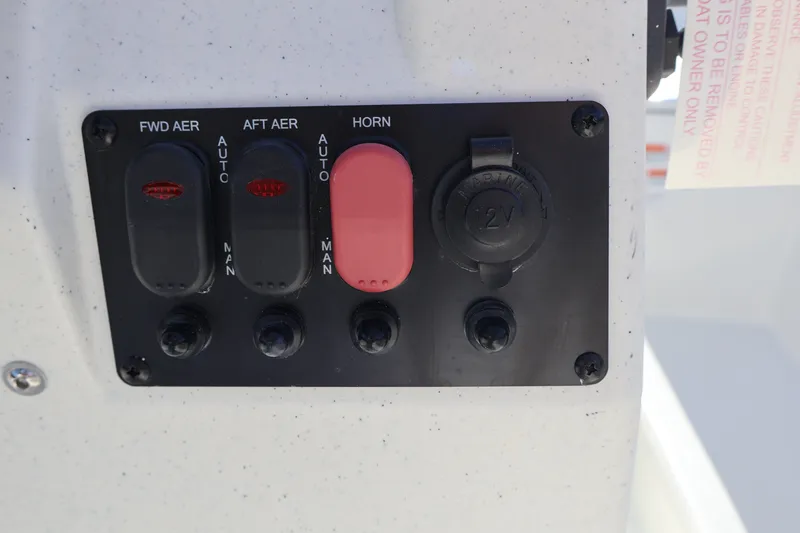 Slide: The Image of Control panel of 2027 Mako Pro Skiff 17 CC with switches and 12V outlet. - 9