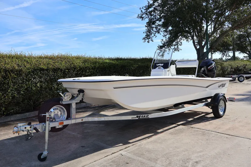 Slide: The Image of 2027 Mako Pro Skiff 17 CC boat on trailer, parked outdoors. - 1