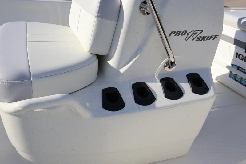Slide: The Image of 2027 Mako Pro Skiff 17 CC boat seat and rod holders detail. - 15
