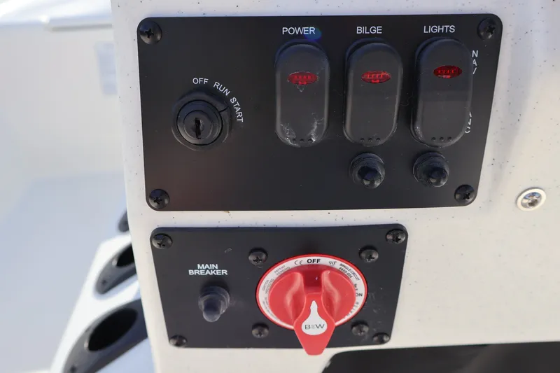 Slide: The Image of Control panel of 2027 Mako Pro Skiff 17 CC with switches and main breaker. - 11