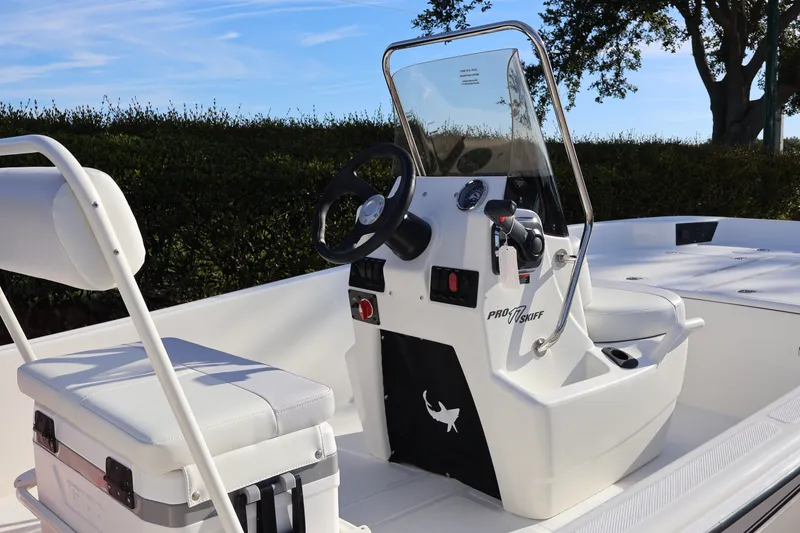 Slide: The Image of 2027 Mako Pro Skiff 17 CC boat interior with steering console and seating. - 7