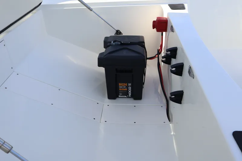Slide: The Image of Battery compartment of 2027 Mako Pro Skiff 17 CC boat, featuring secure wiring setup. - 14