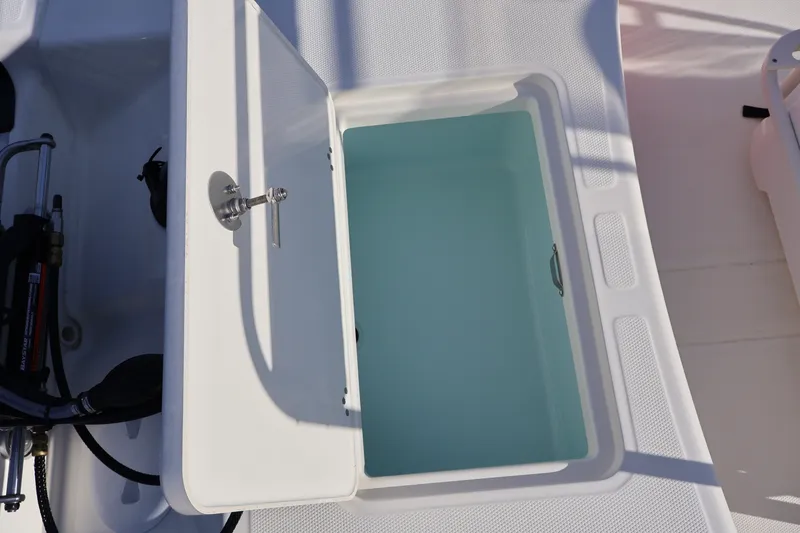 Slide: The Image of Open storage compartment on 2027 Mako Pro Skiff 17 CC boat. - 12