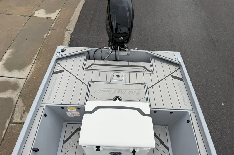 Slide: The Image of 2027 Tracker Bass Tracker Classic CC boat deck with motor, featuring sleek design and modern finishes. - 19
