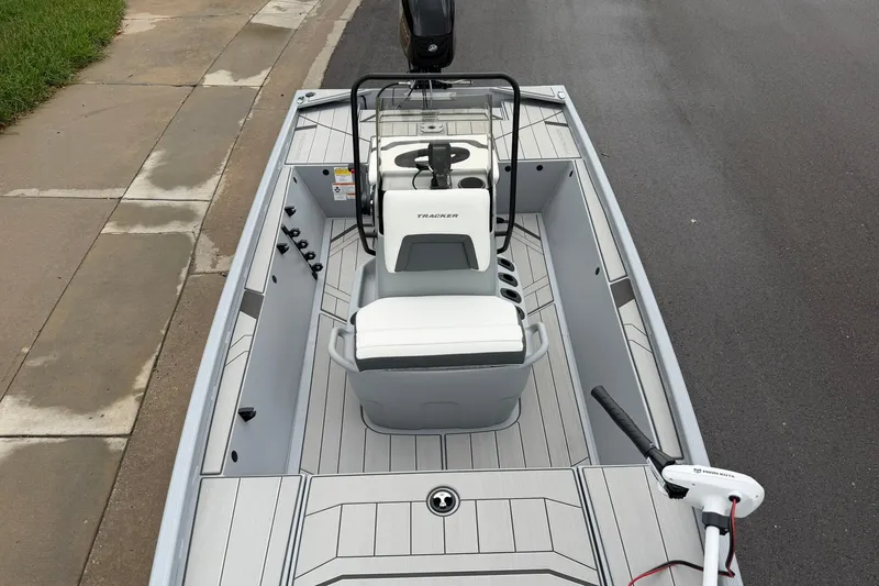 Slide: The Image of 2027 Tracker Bass Tracker Classic CC boat with sleek interior design on a wet road. - 14